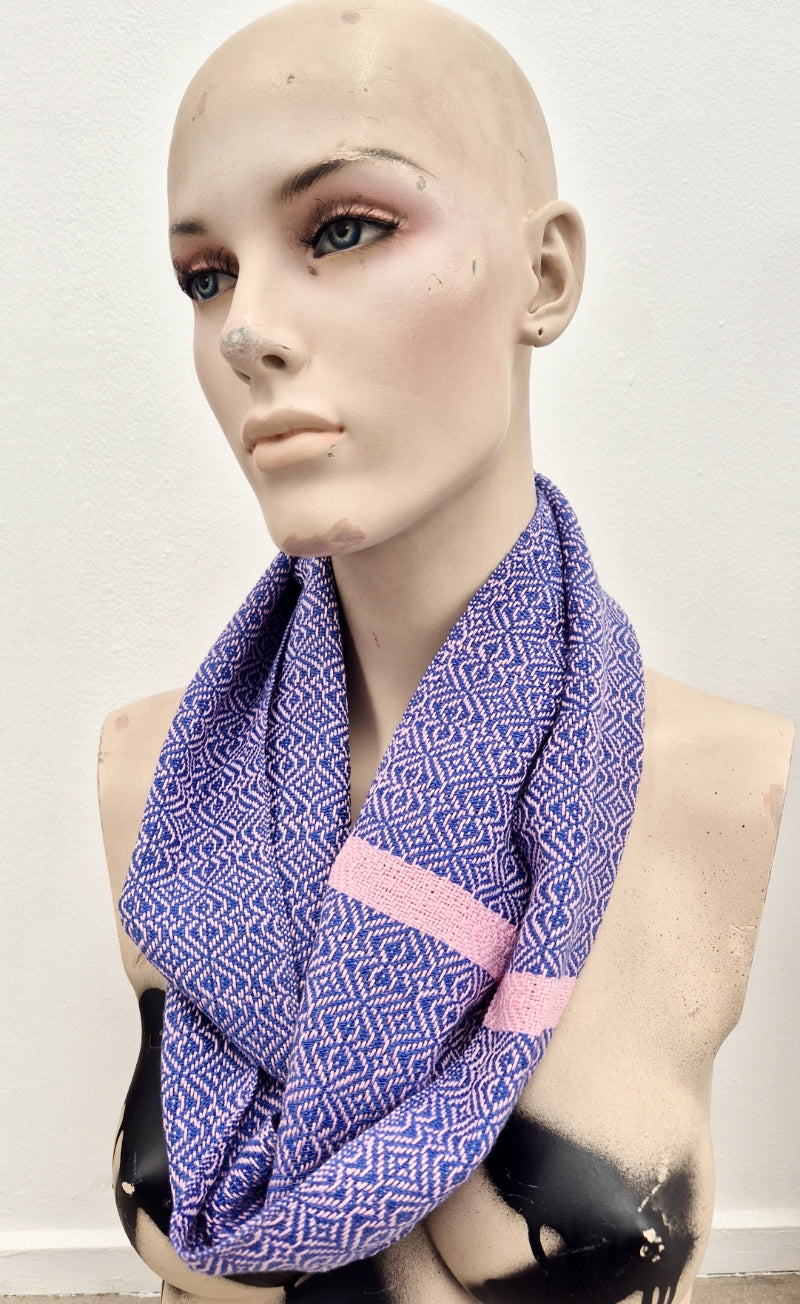 Handwoven scarf in blue and dusty pink worn by a creepy mannequin