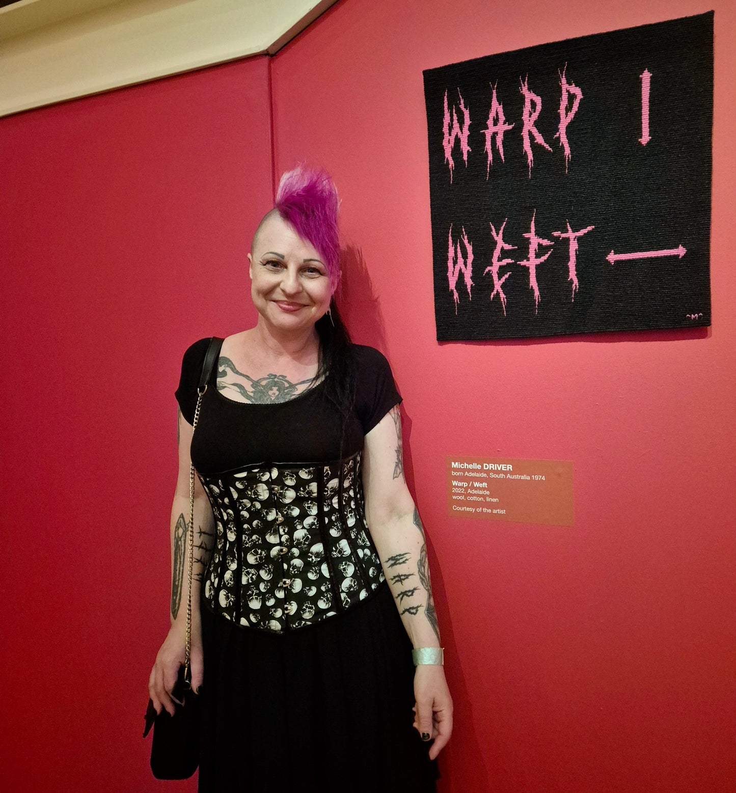 Michelle Driver standing in front of her artwork at Radical Textiles Art Gallery of South Australia 2025