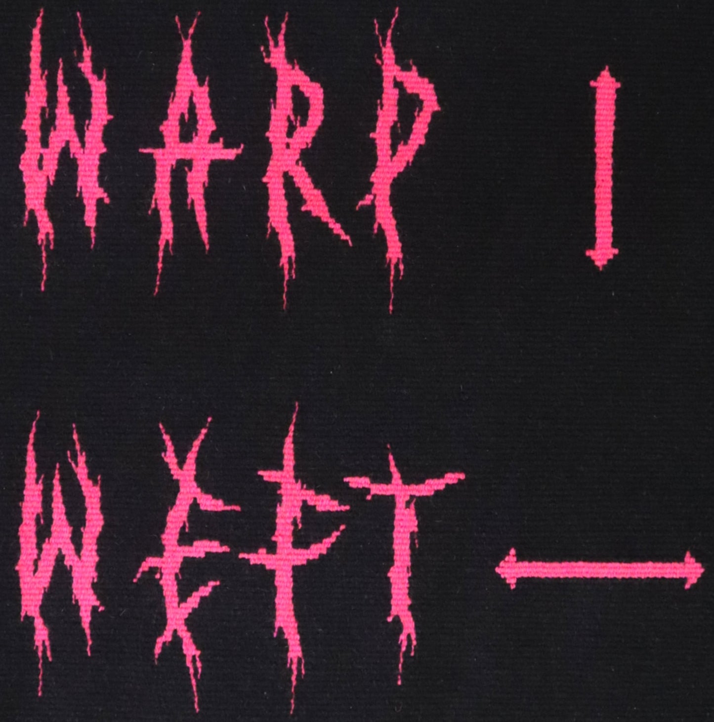 Artwork made in handwoven tapestry with the words warp and weft in pink deathmetal style lettering