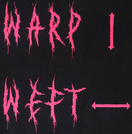 Artwork made in handwoven tapestry with the words warp and weft in pink deathmetal style lettering