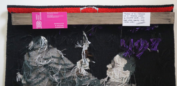 back of hand woven tapestry showing the batten and mounting
