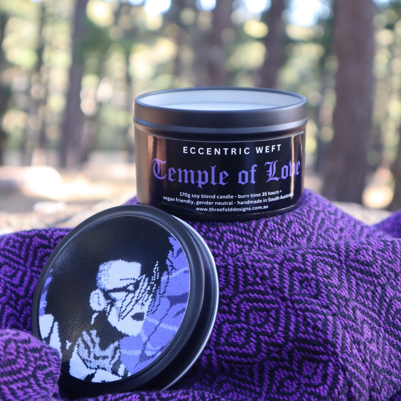 handmade soy candle with artwork of jonny slut specimen on lid - teak neroli tobacco hay goth candle
