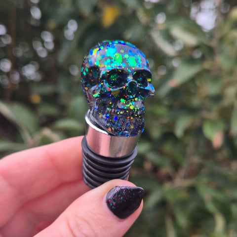 Green blue glitter skull on top of a wine bottle stopper