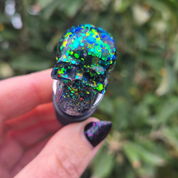 Green blue glitter skull on top of a wine bottle stopper
