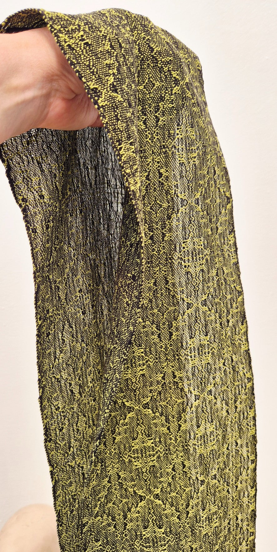 mannequin wearing fine handwoven cotton scarf in bright lime green and black