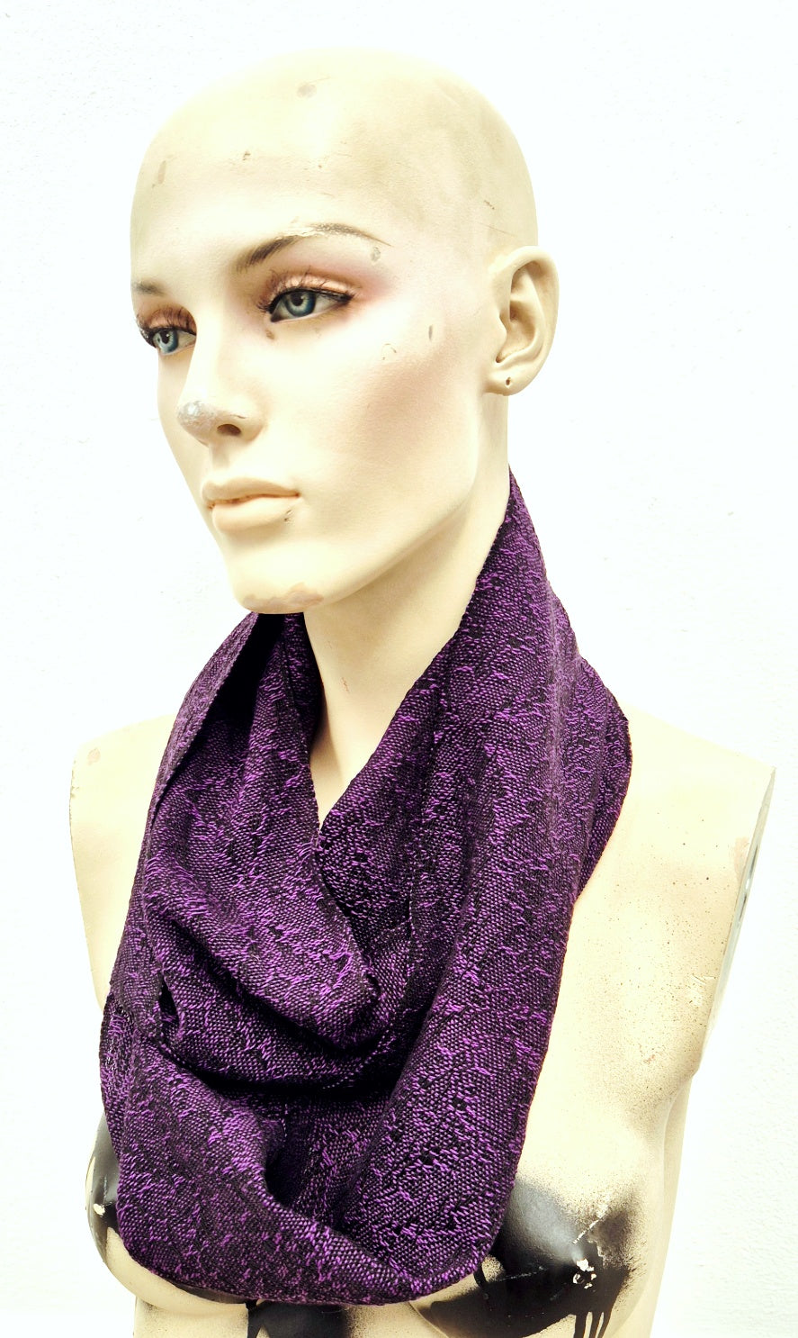 Purple fine handwoven scarf on a mannequin with a white background