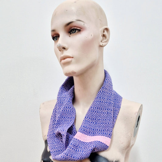 handwoven infinity scarf in blue and dusty pink cotton worn by a creepy mannequin