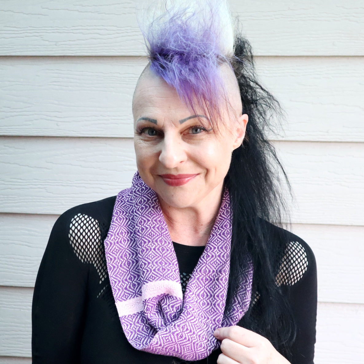 Michelle wearing a short handwoven infinity scarf in purple and dusty pink