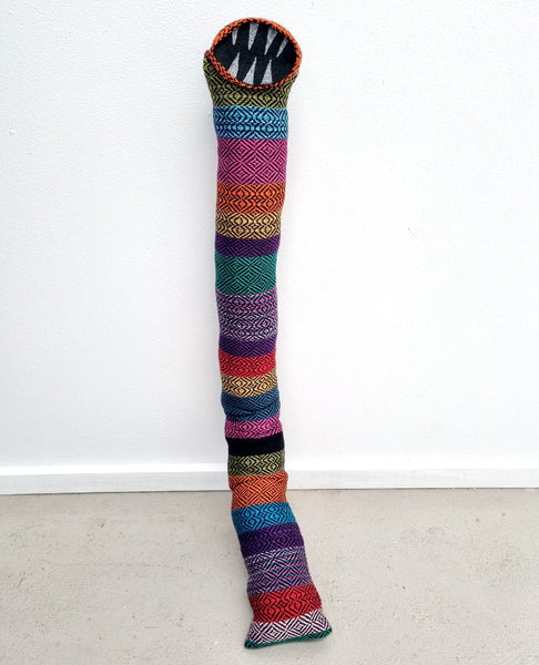 tube creature made with multi coloured handwoven fabric with felt teeth