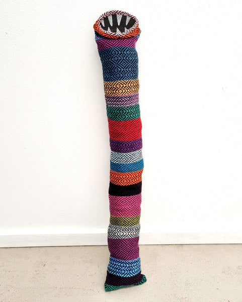 tube creature made with multi coloured handwoven fabric with felt teeth
