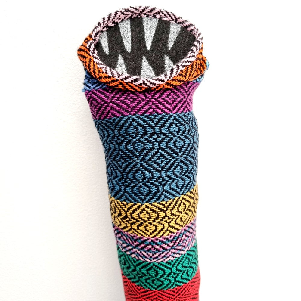 tube creature made with multi coloured handwoven fabric with felt teeth