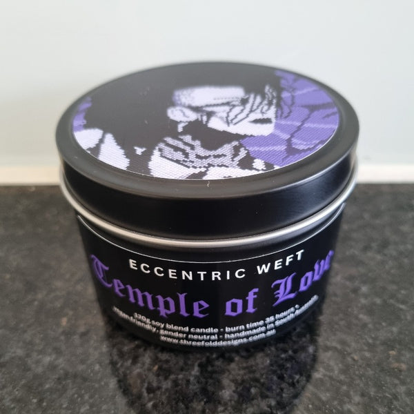 handmade soy candle with artwork of jonny slut specimen on lid - teak neroli tobacco hay goth candle