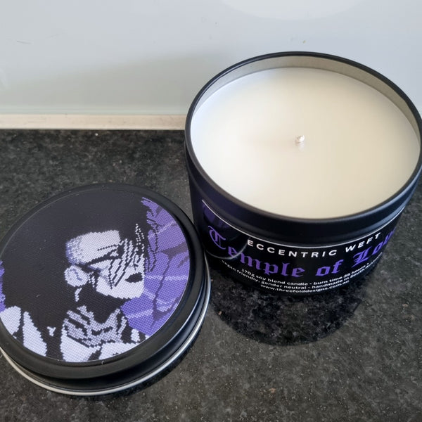 handmade soy candle with artwork of jonny slut specimen on lid - teak neroli tobacco hay goth candle