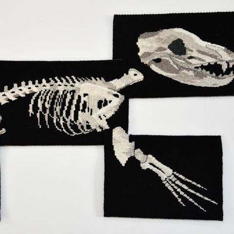 Handwoven tapestry artwork made up on skeletons of various animals