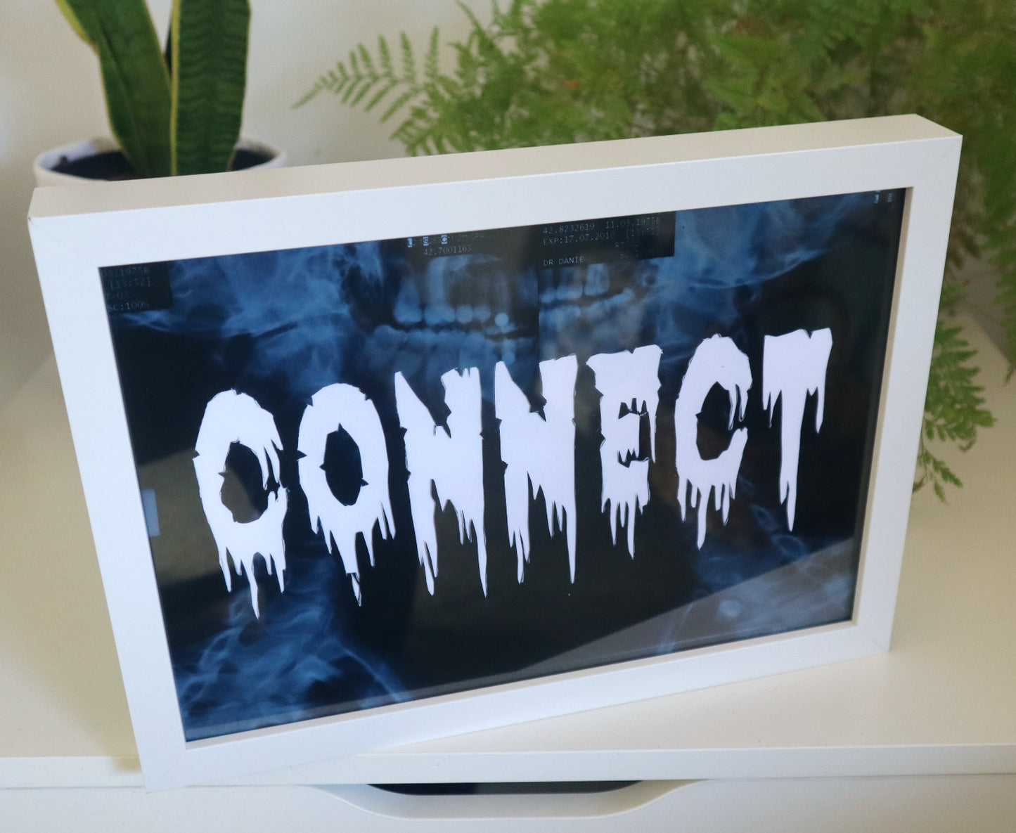 artwork made out of x-ray film with the word connect cut out 