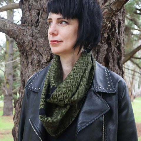 alternative girl in leather jacket wearing handwoven olive green scarf