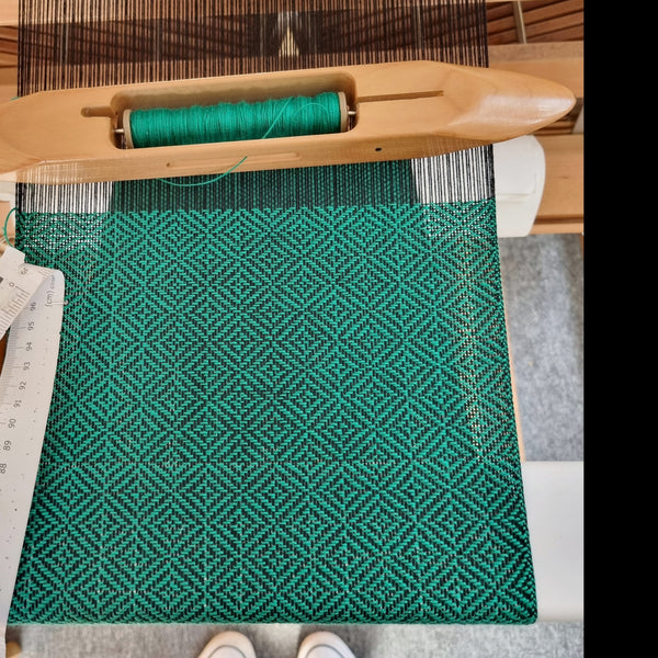 handwoven emerald green short loop scarf, on weaving loom