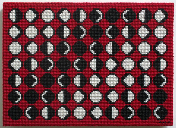 needlepoint of the phases of the moon in a geometric pattern, black white and red
