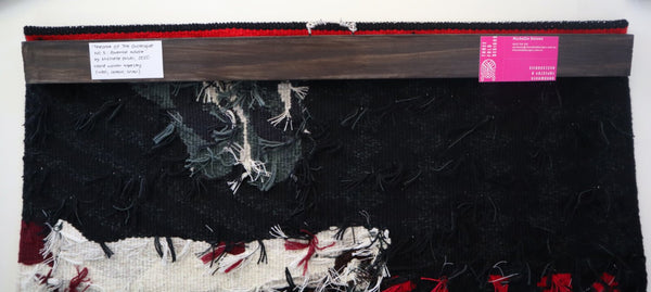 back of hand woven tapestry showing the batten with mounting